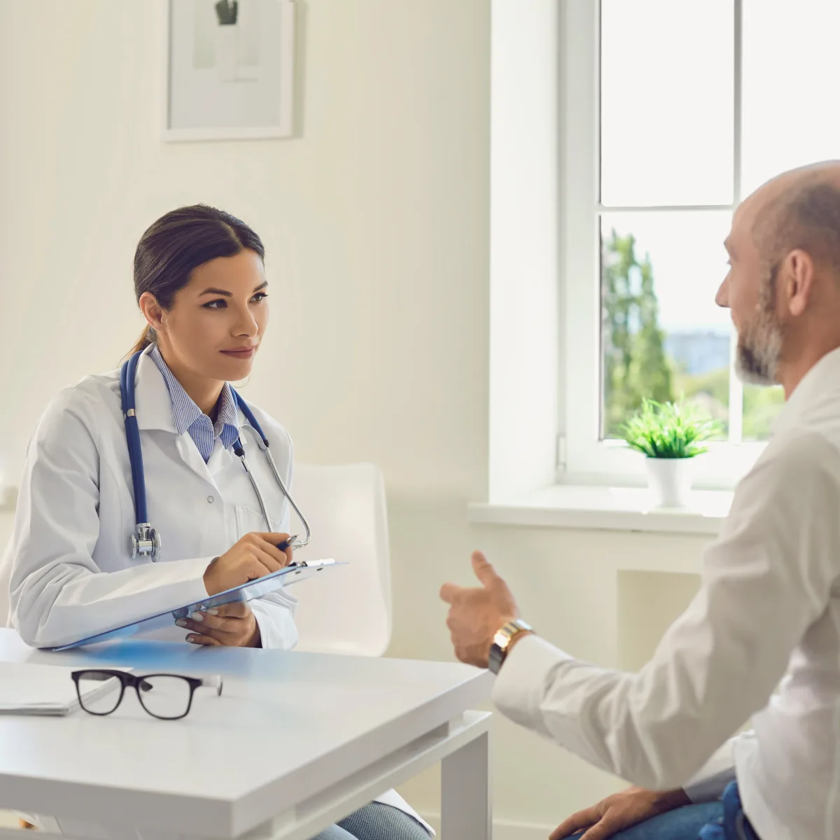 Dermatologist discussing hair restoration options with a male patient at a consultation