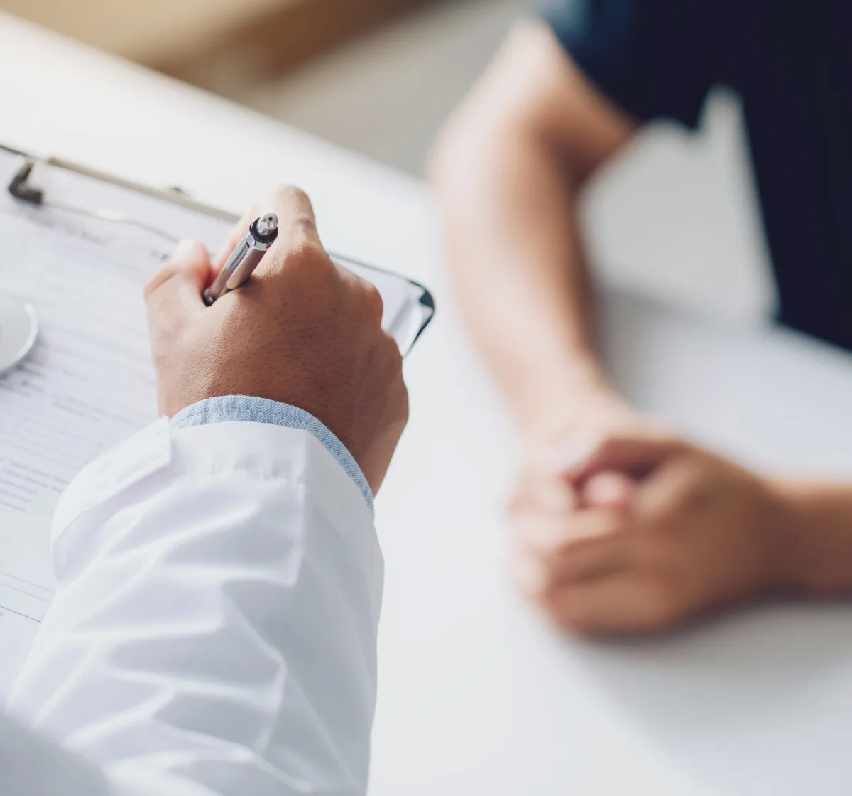 Patient reviewing a psoriasis treatment plan with a dermatologist