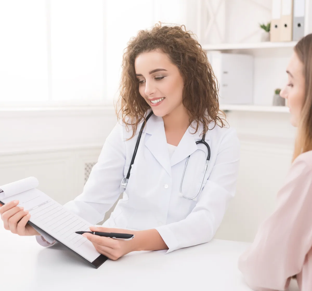 Dermatologist reviewing a patient&rsquo;s skin history during a skin cancer evaluation