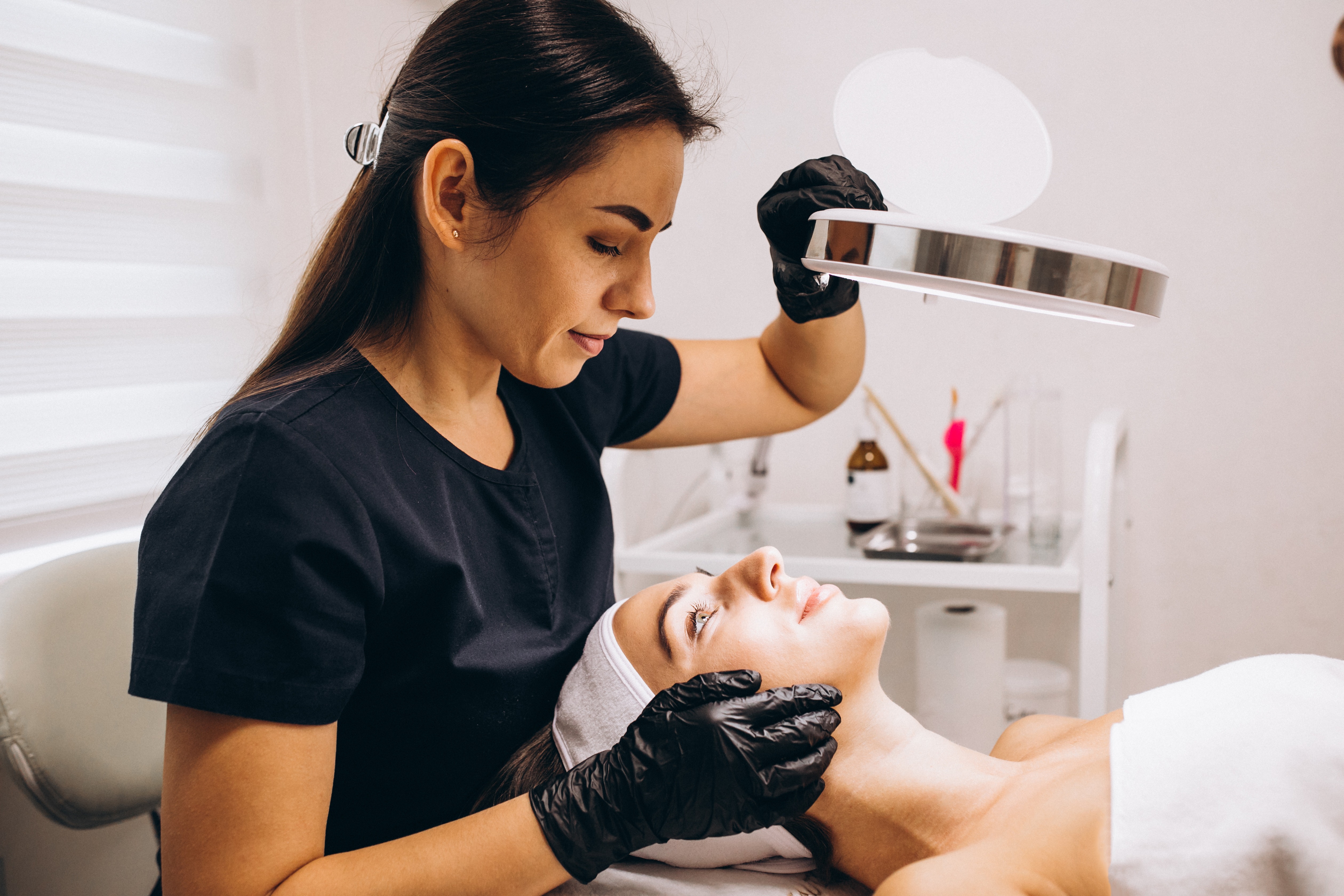 Dermatology provider assessing a patient's brow during a cosmetic consultation