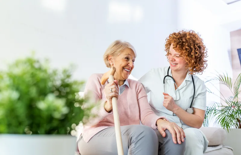 Senior woman relaxing outdoors with a care team member during a short-term respite stay