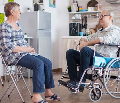 Elderly sitting on wheelchair in their home