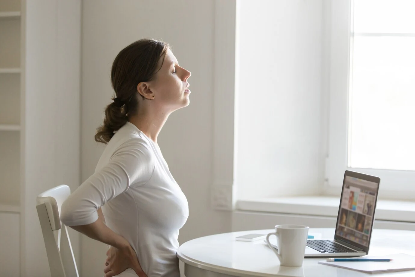 Understand Low Back Pain Causes and Effective Treatment Options A doctor explaining low back pain causes and treatment options to a patient during consultation