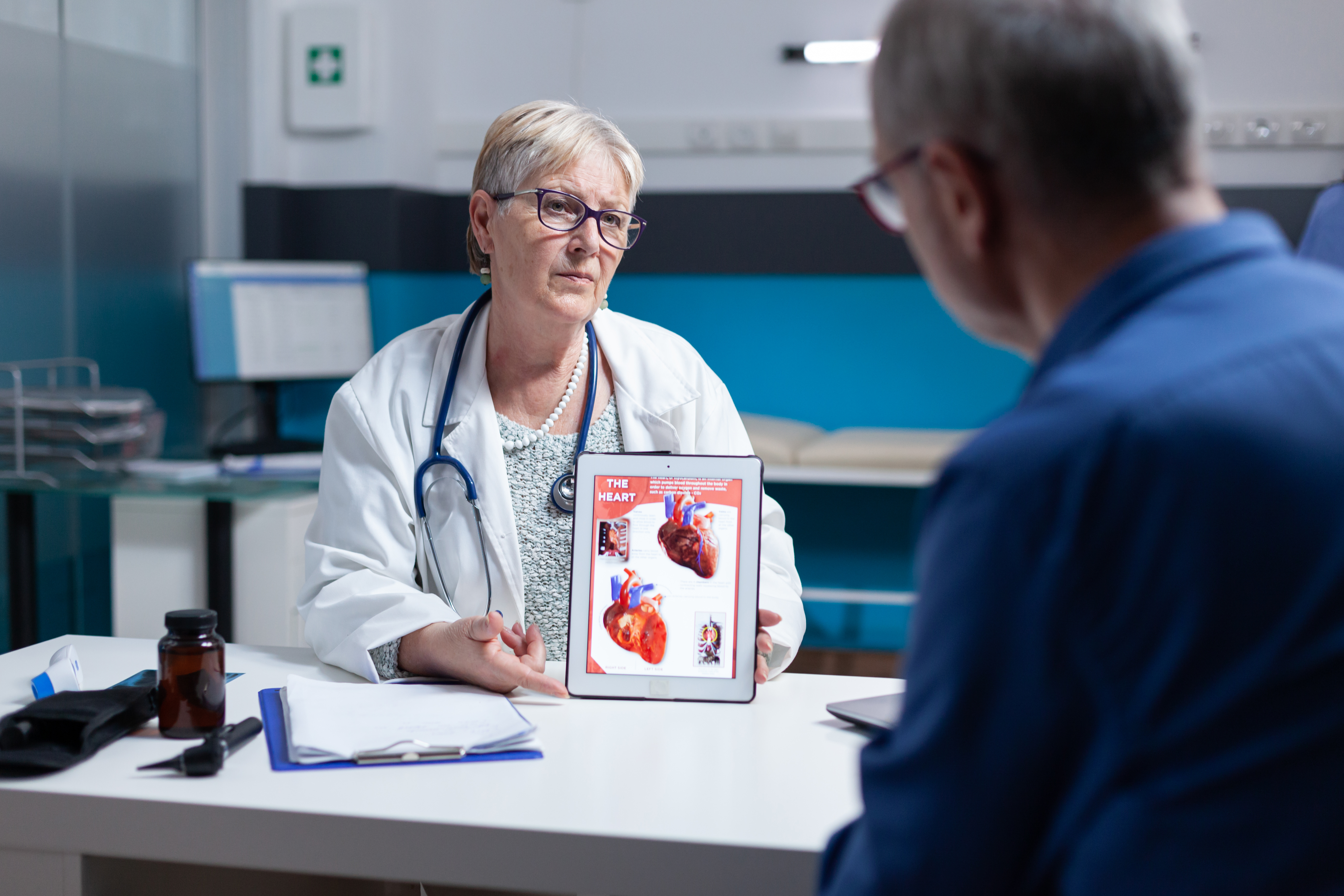 When Should You Get Your First Cardiac Screening? Patient discussing first cardiac screening and heart health assessment with a medical professional