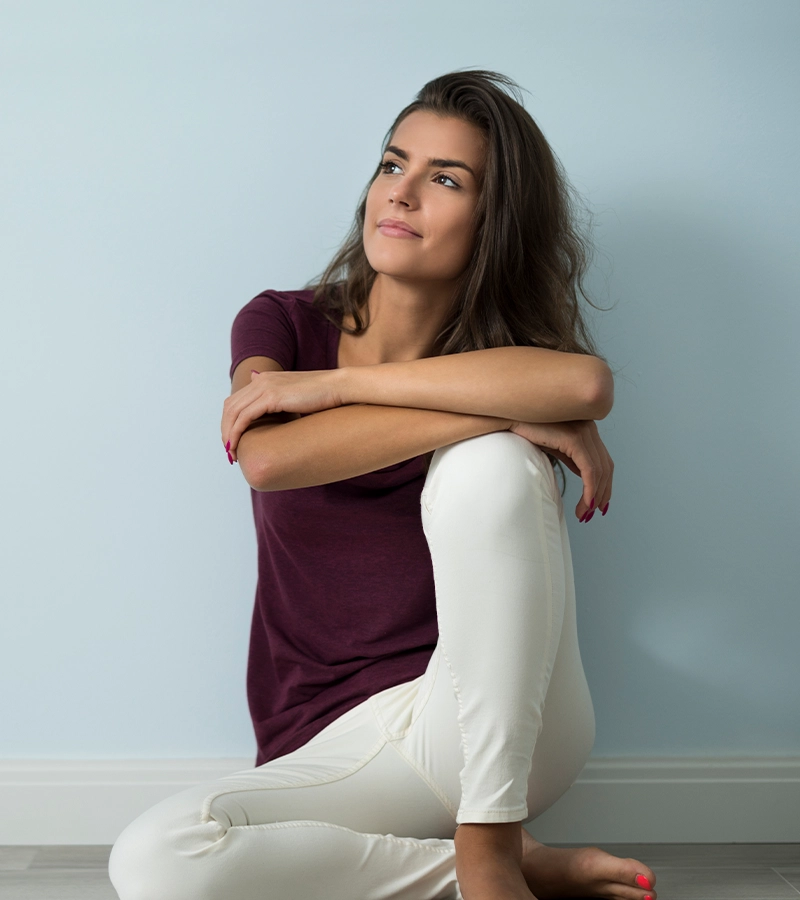 Woman reflecting at home, at ease in the care she has found