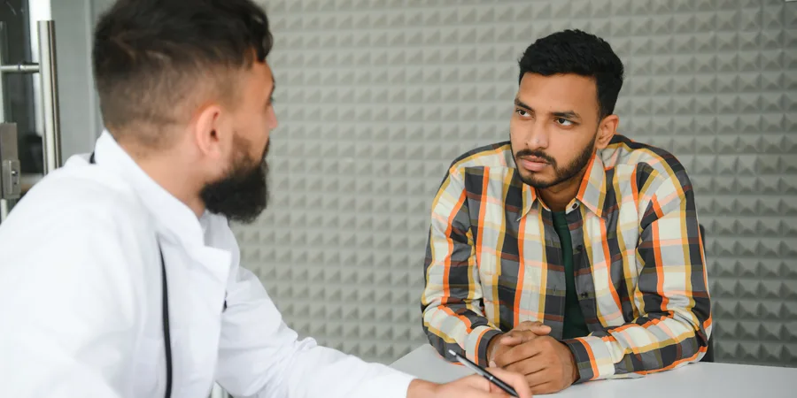 Man in a confidential consultation with his doctor