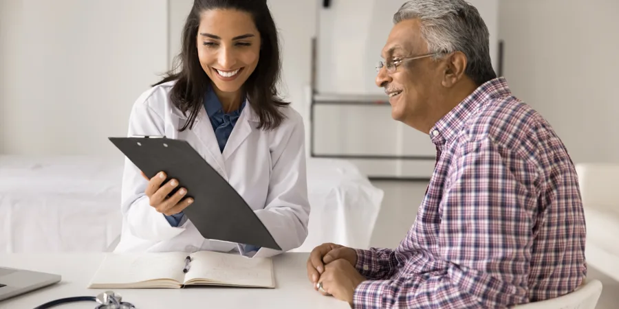 Senior man reviewing his prostate health report with a doctor