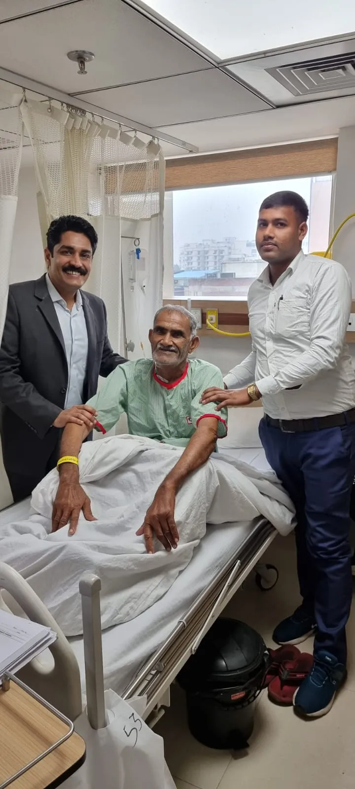 Dr. Kapoor and a colleague with a recovering patient