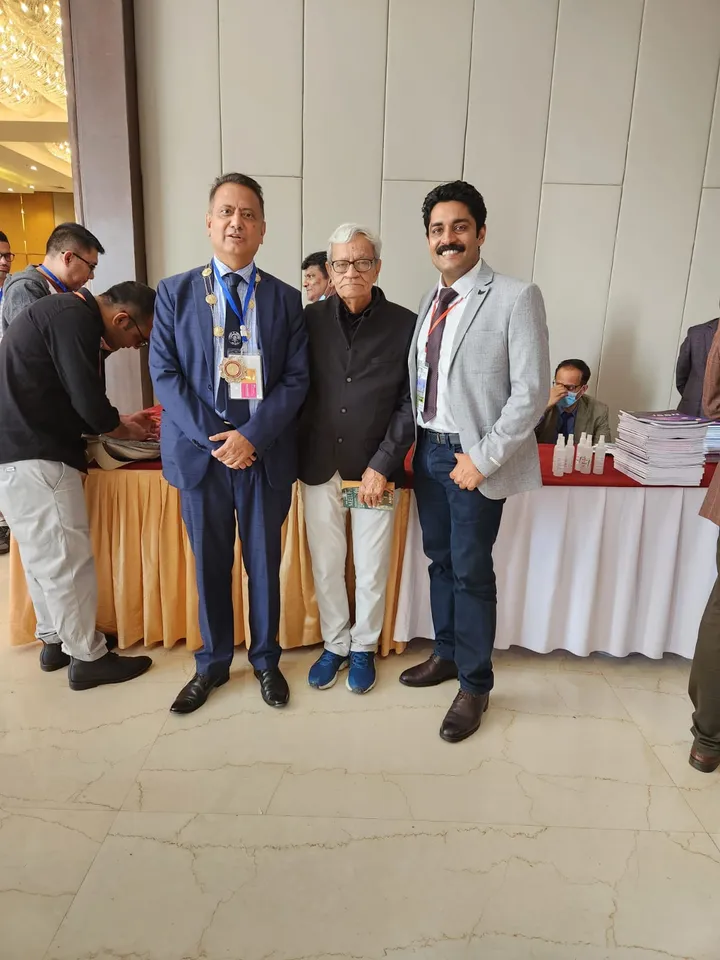 Dr. Kapoor with senior surgeons at a conference registration desk