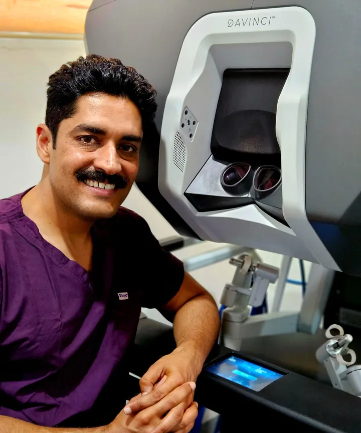 Dr. Kapoor at the da Vinci surgical console, close-up