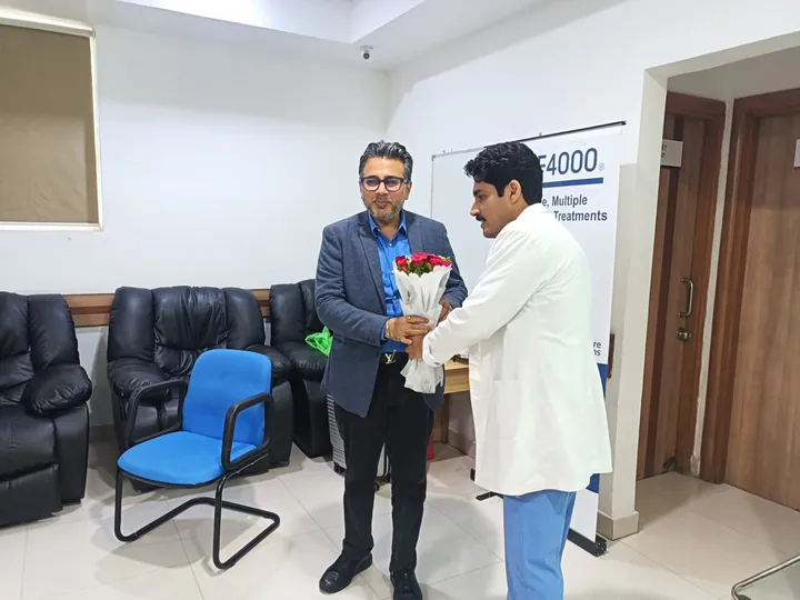 Dr. Kapoor felicitated by a colleague at a hospital event