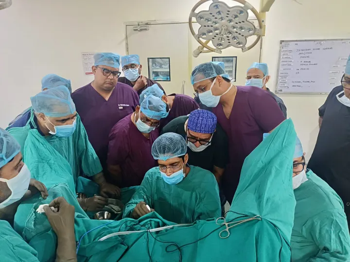 Surgical team gathered around the operating table during a live surgery workshop
