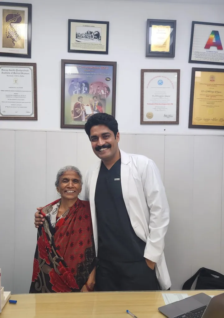 Dr. Kapoor with an elderly patient in his consulting room