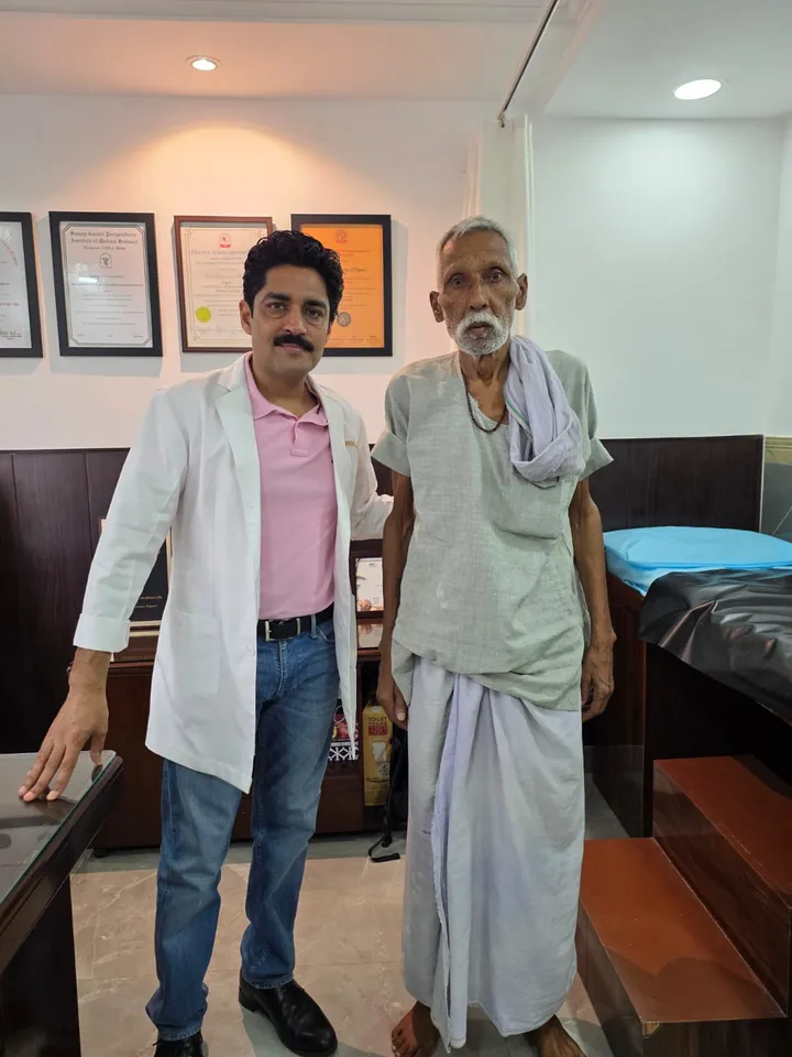 Dr. Kapoor with an elderly patient after his consultation