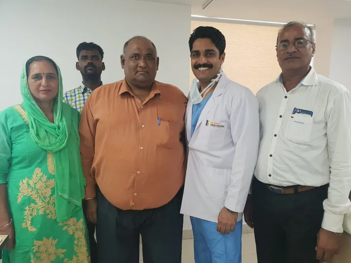 Dr. Kapoor with a patient and their family after successful treatment