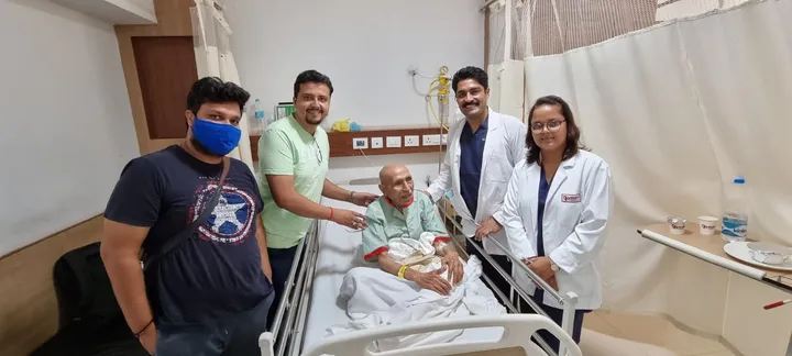 Dr. Kapoor and team with a recovering patient and his family