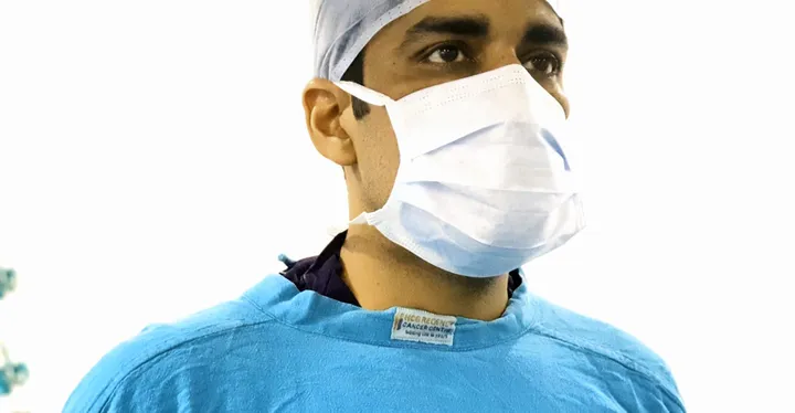 Dr. Kapoor in surgical cap and mask, ready for the operating theatre