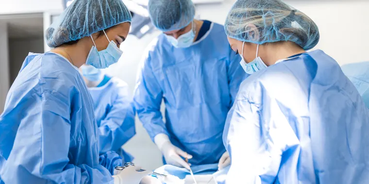 Surgical team operating in a modern theatre
