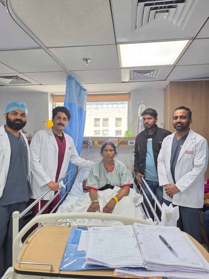 Dr. Kapoor and the ward team with a patient on the day of discharge
