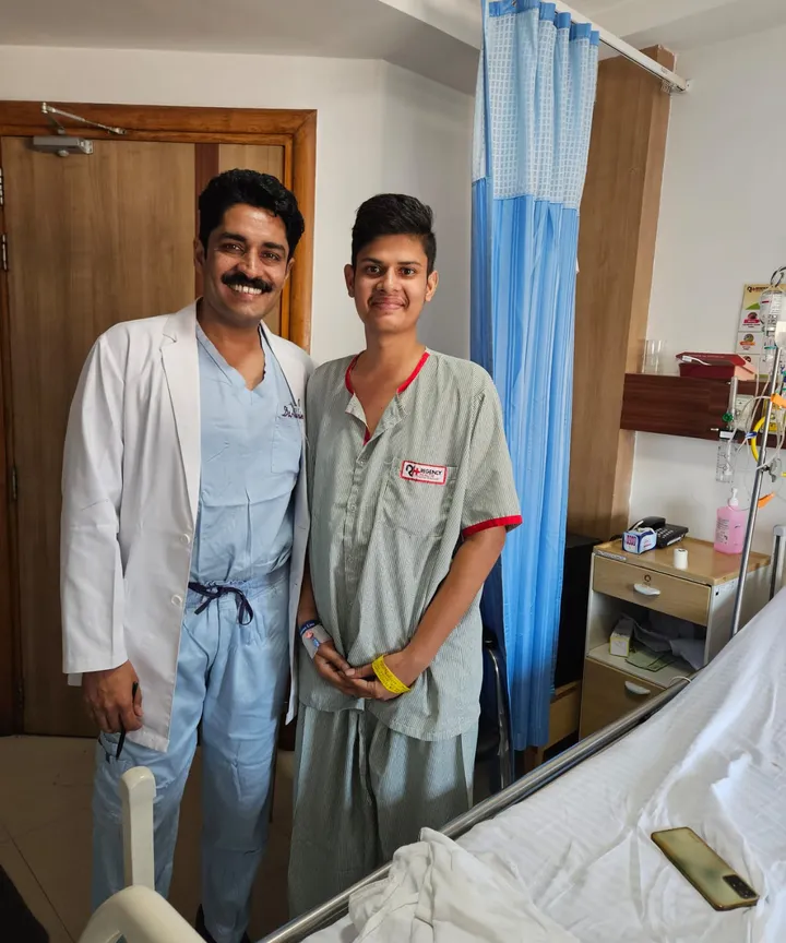 Dr. Kapoor with a young patient in the ward