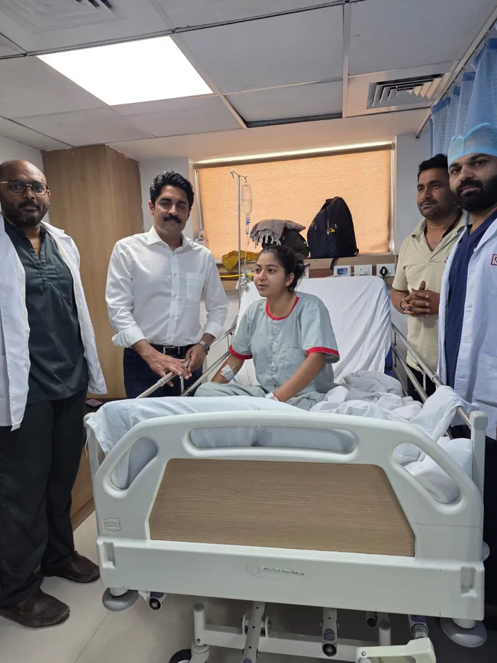 Dr. Kapoor and his team with a young patient in the ward