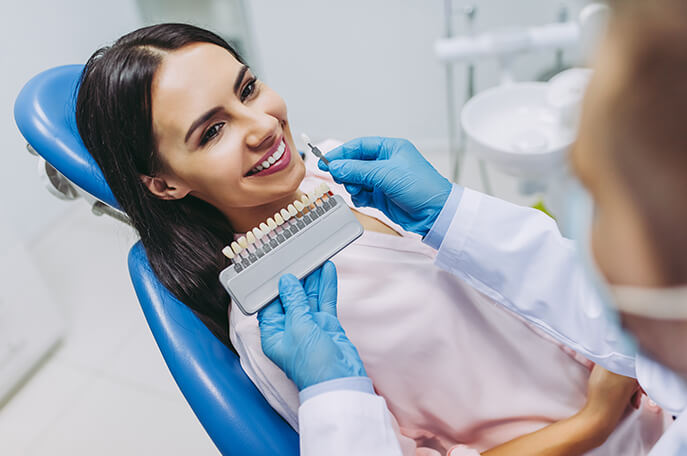 An image of a smile patient sitting on a dental chair