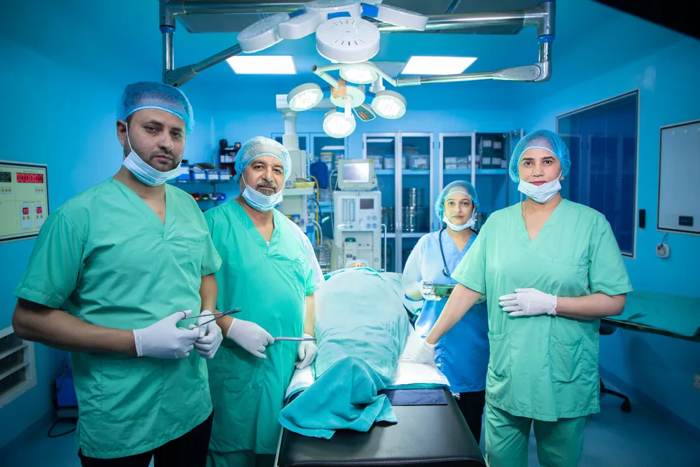 Surgical team performing an operation in a hospital operating theatre