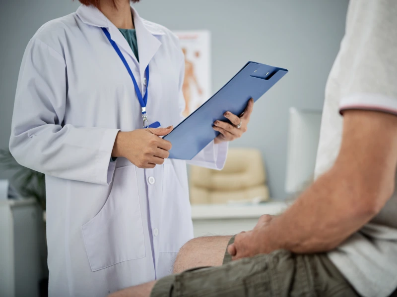 Clinician going through an existing report on screen with an older patient