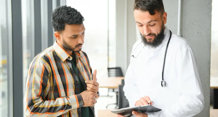 Doctor consulting a patient about head and neck cancer treatment