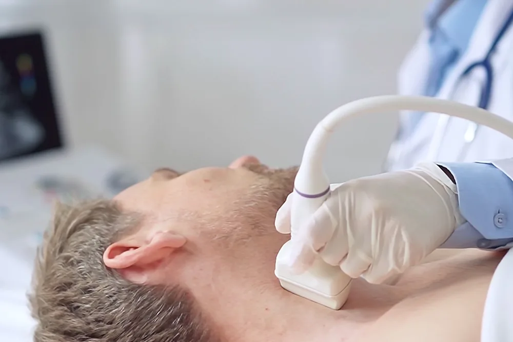 Clinician reviewing a parathyroid localisation scan