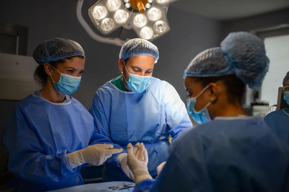 Robotic surgical arms positioned for a thyroid procedure