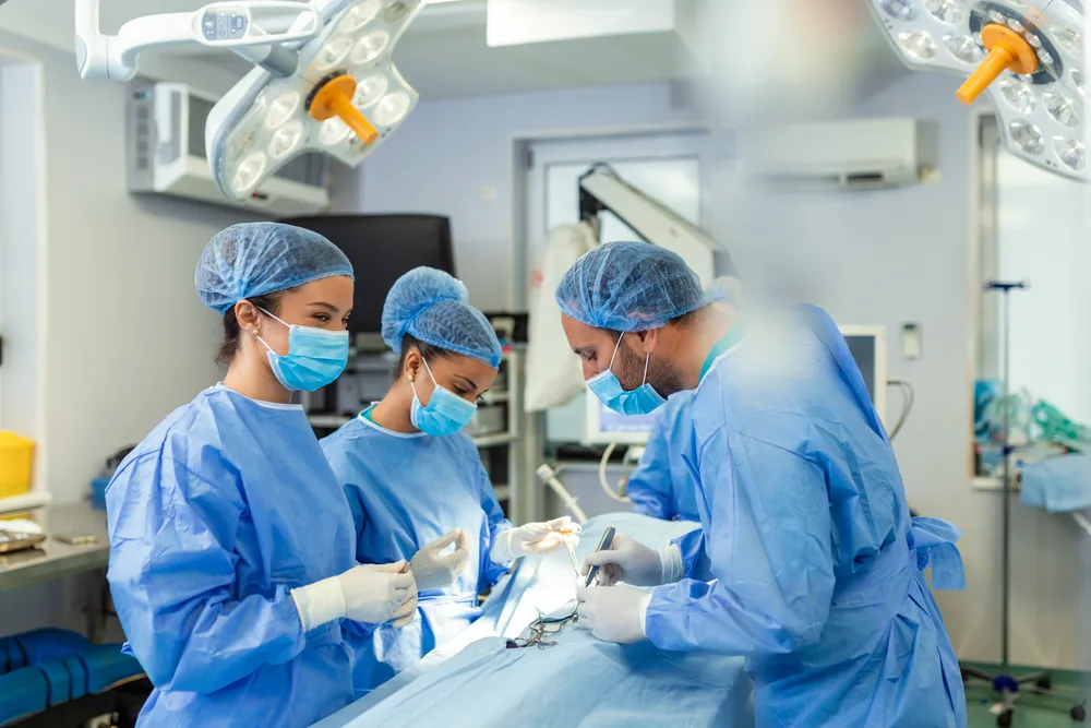 Surgical team operating together in a hospital operating theatre