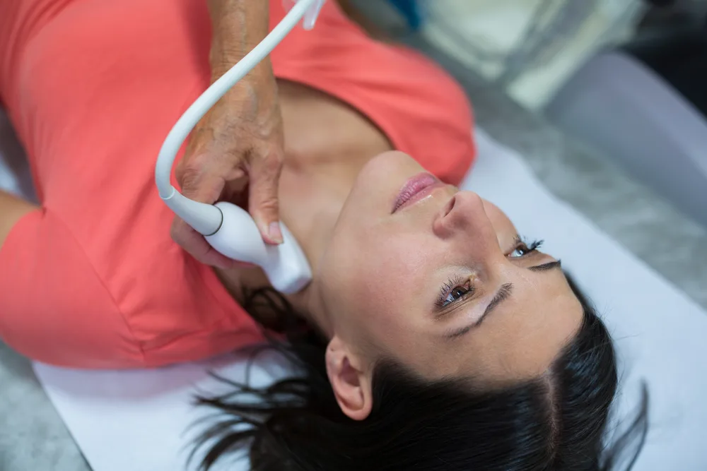 Thyroid ultrasound being performed on a patient’s neck