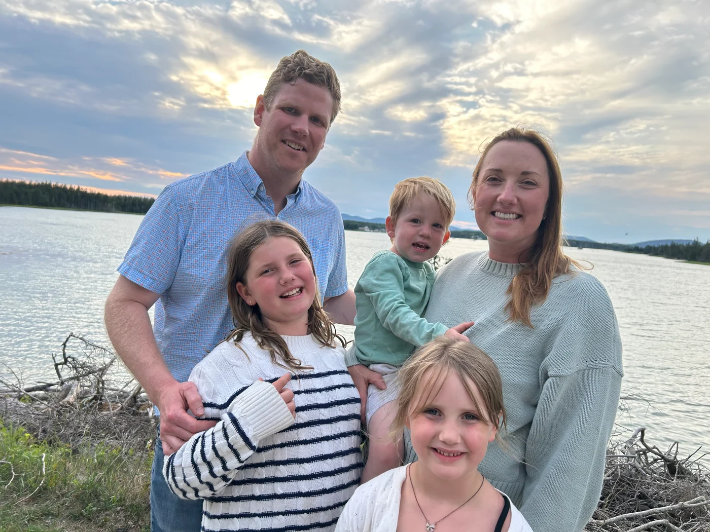 Dr. Laura Twist with her husband and their three children beside a lake at sunset