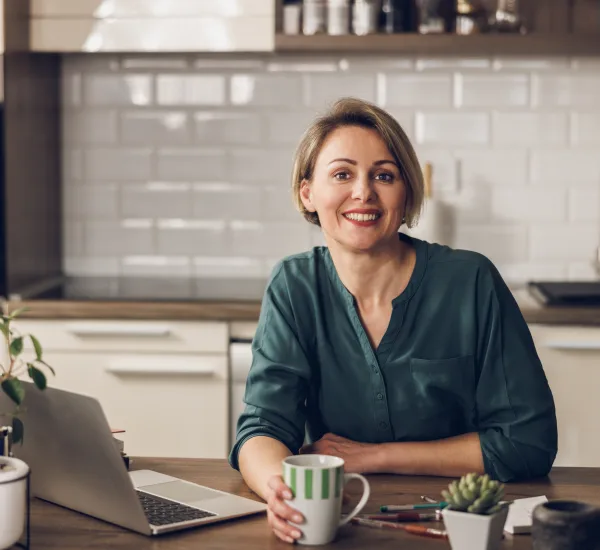 Montana woman booking a virtual visit on her laptop at her kitchen table