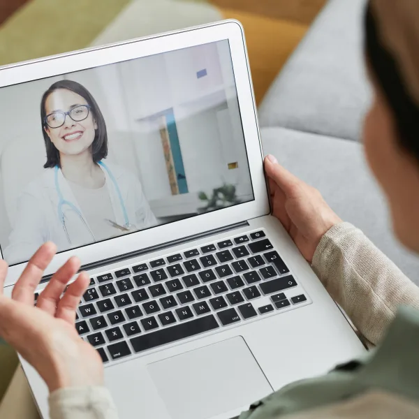 Virtual women’s health consultation with a board-certified OB/GYN on a laptop at home